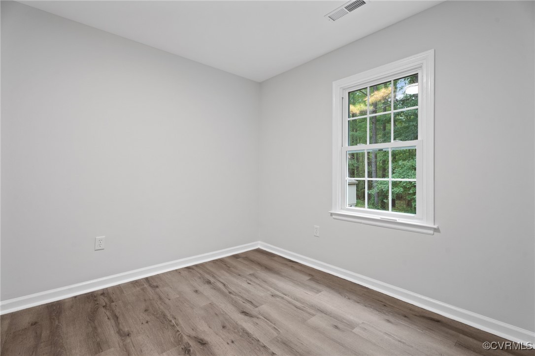 7201 Courthouse Road Chesterfield, VA 23832 - Photo 18 of 41 an empty room with wooden floor and windows