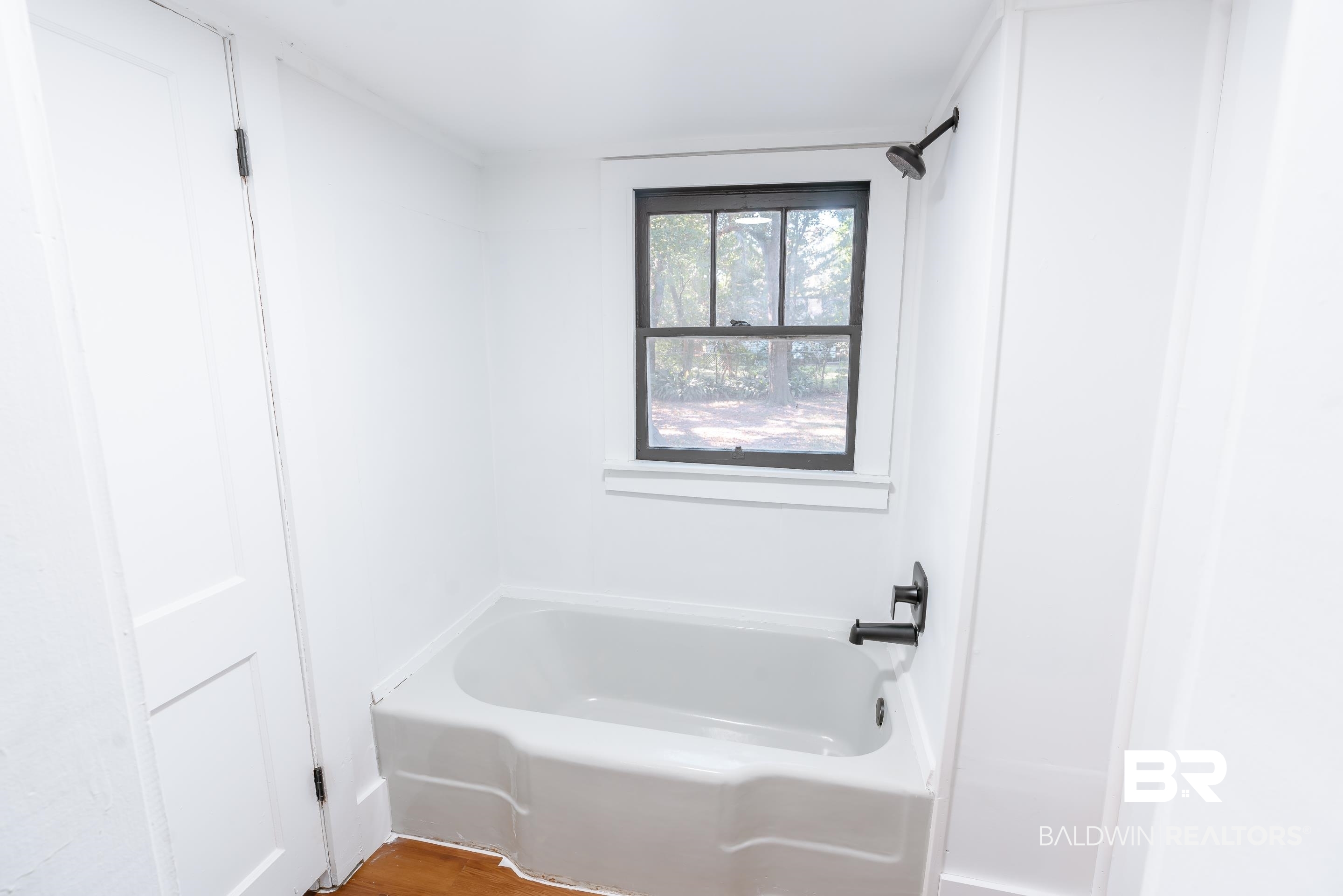 166 Crenshaw Street Mobile, AL 36606 - Photo 12 of 24 Bathroom featuring hardwood / wood-style flooring and shower / washtub combination