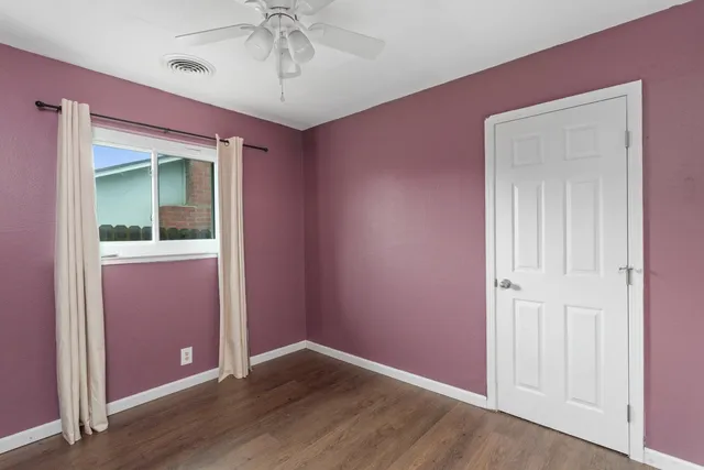 an empty room with closet and entryway