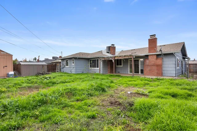 a front view of a house with yard and green space