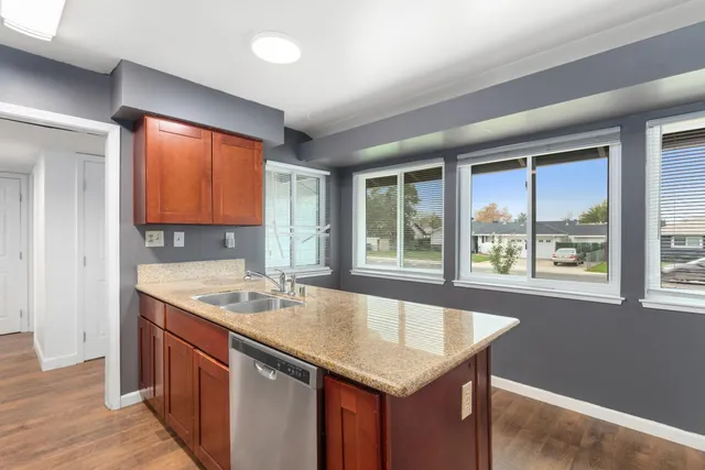 a kitchen with a sink stove and cabinets