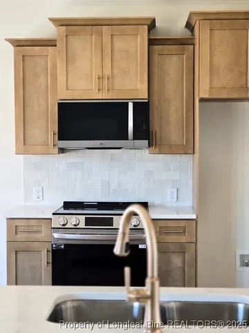 a kitchen with a stove and a microwave
