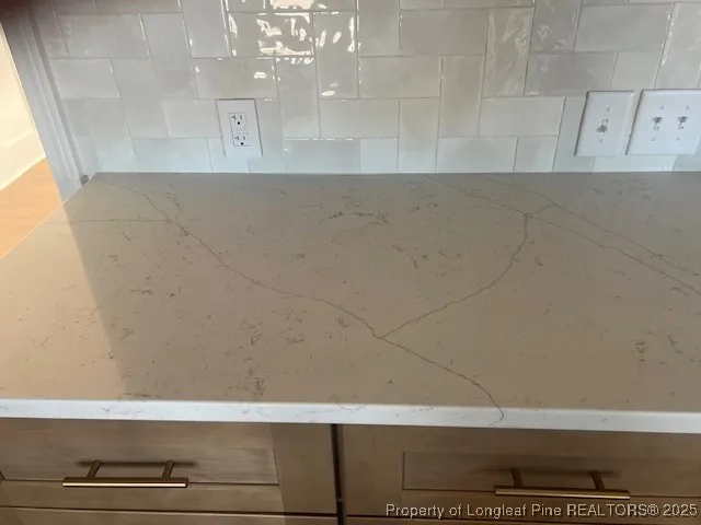 a view of empty room with wooden floor and fireplace