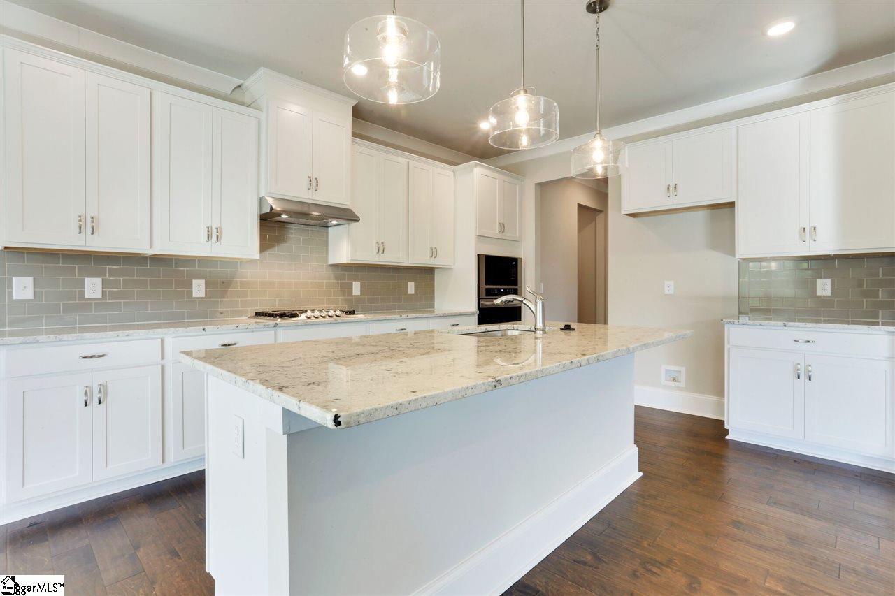 601 Rutland Court, Unit SITE 16 Greer, SC 29651 - Photo 11 of 34 Stainless steel built-in appliances, 42" cabinets with crown molding, granite counters and tile backsplash!