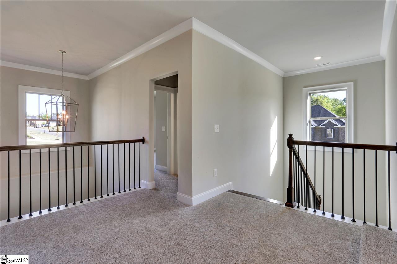 601 Rutland Court, Unit SITE 16 Greer, SC 29651 - Photo 22 of 34 Overlooks 2 story foyer with wrought iron spindles and finished on-site stained oak tread turn-back staircase