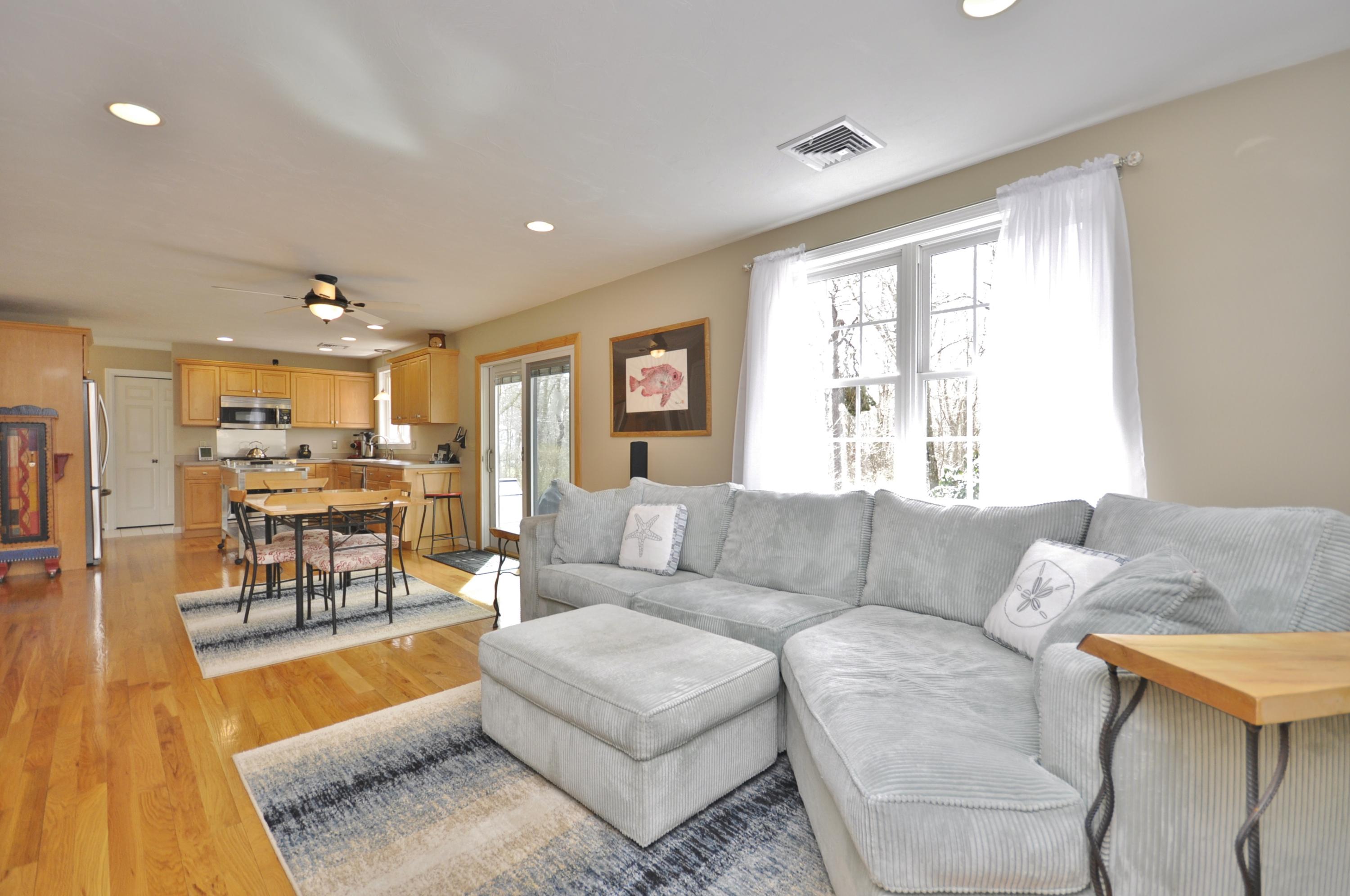 2 Crowell Road Sagamore Beach, MA 02562 - Photo 11 of 27 a living room with furniture and a table