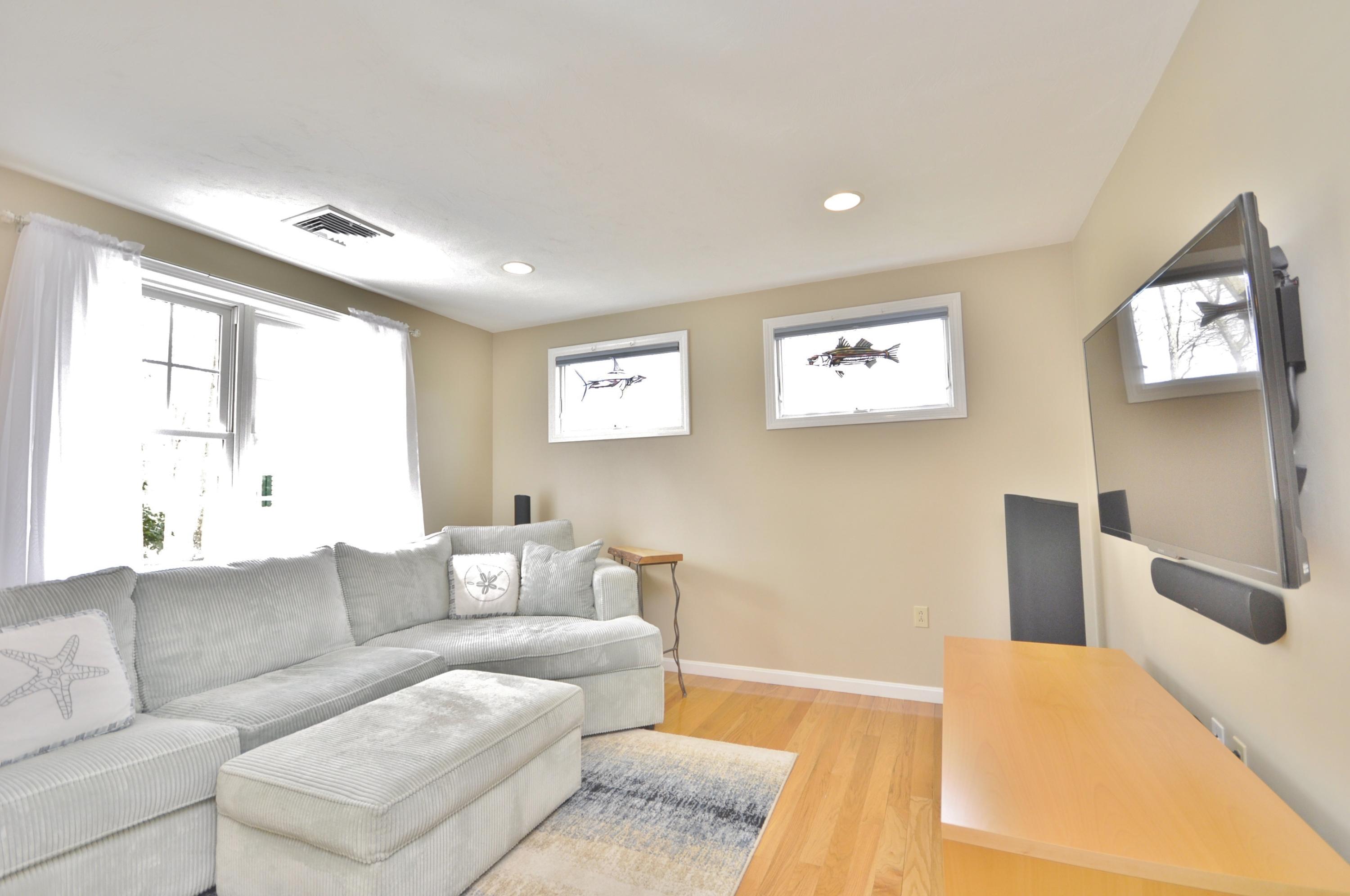 2 Crowell Road Sagamore Beach, MA 02562 - Photo 12 of 27 a living room with furniture and a large window
