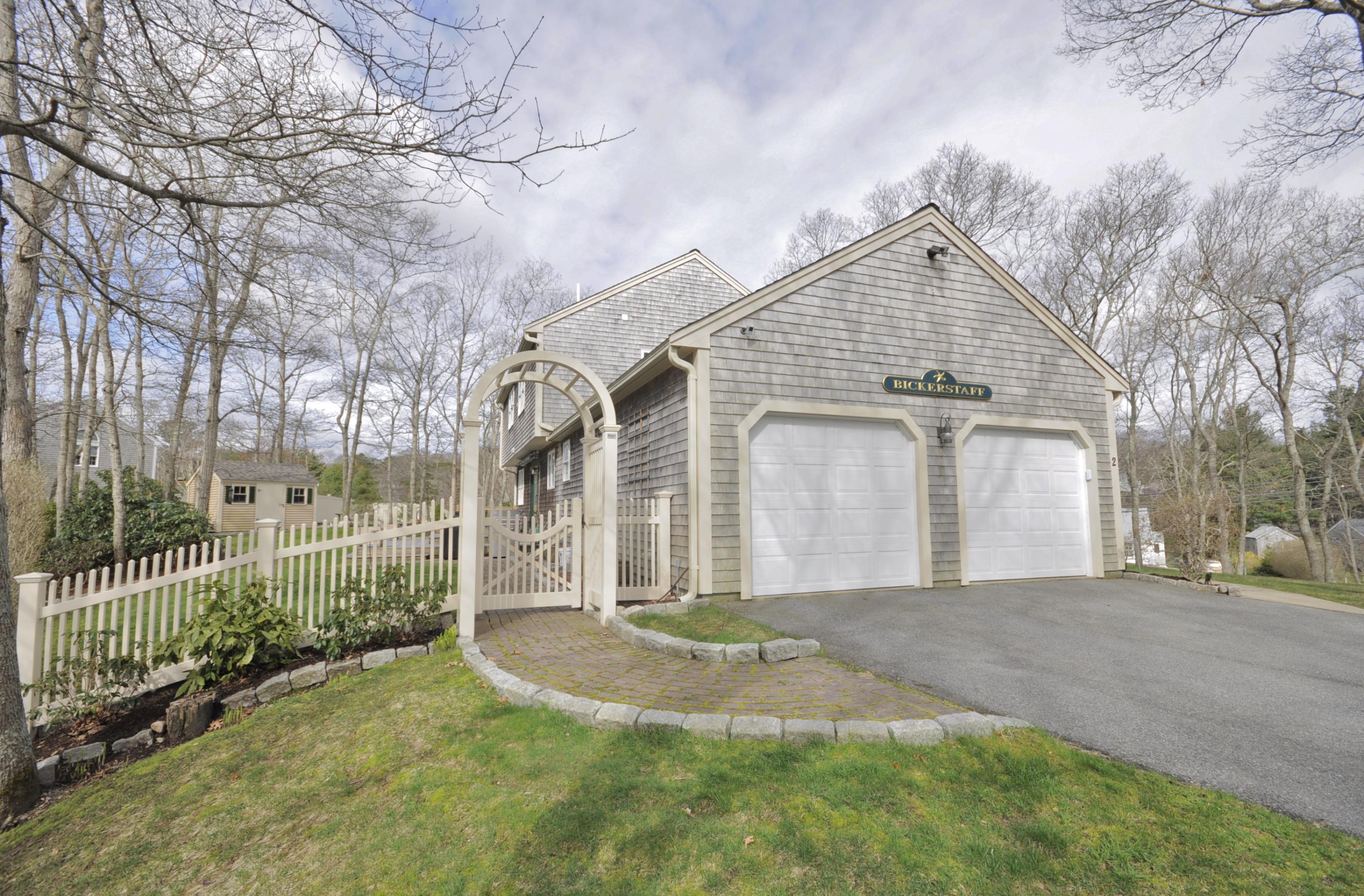 2 Crowell Road Sagamore Beach, MA 02562 - Photo 2 of 27 a front view of a house with a yard and garage