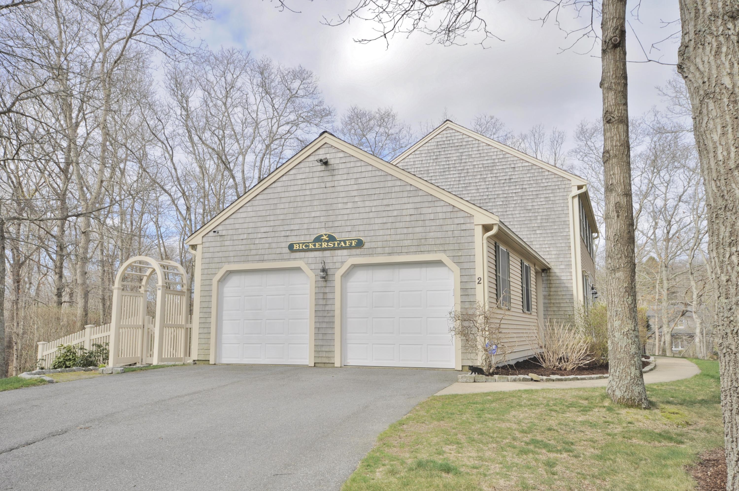 2 Crowell Road Sagamore Beach, MA 02562 - Photo 27 of 27 a view of a white house with a yard and garage