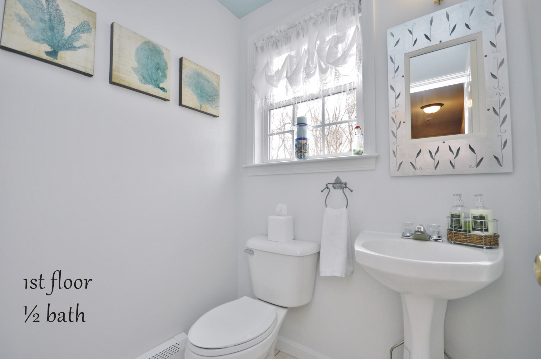 2 Crowell Road Sagamore Beach, MA 02562 - Photo 8 of 27 a bathroom with a toilet sink and mirror