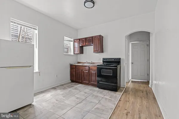 a kitchen with granite countertop a stove and a refrigerator