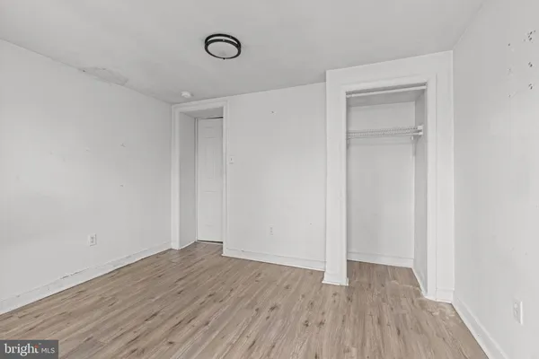 a view of a room with wooden floor and closet