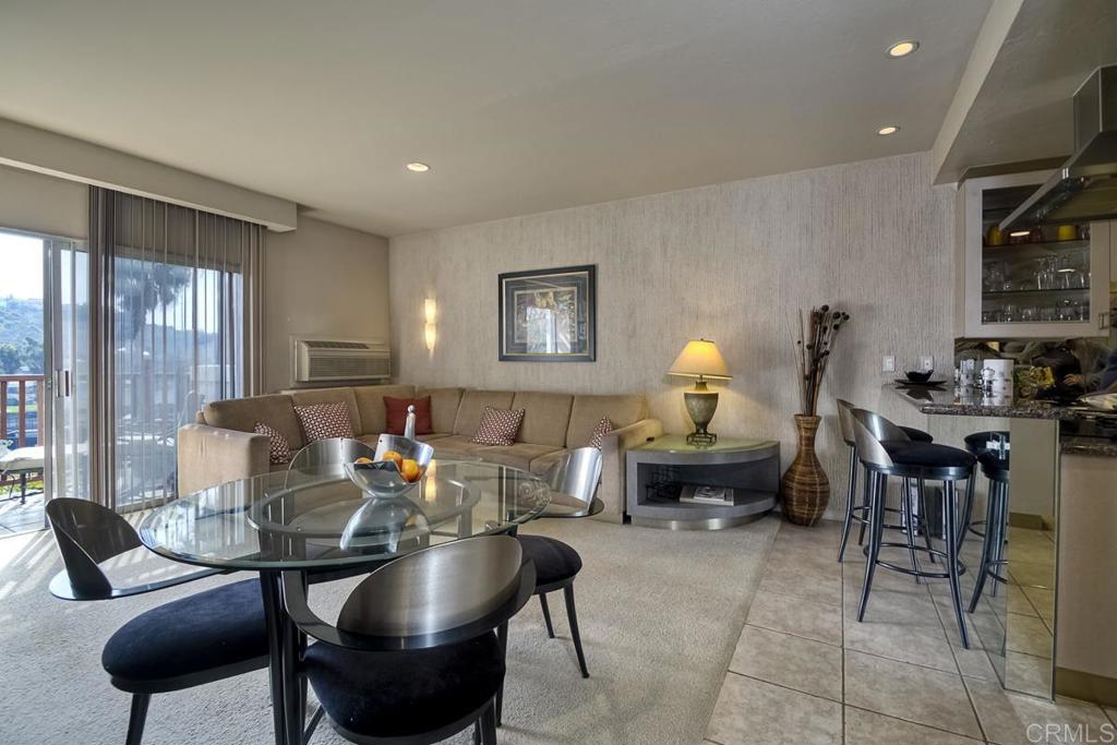 2003 Costa Del Mar Road, Unit 694 Carlsbad, CA 92009 - Photo 1 of 1 a living room with furniture and a lamp