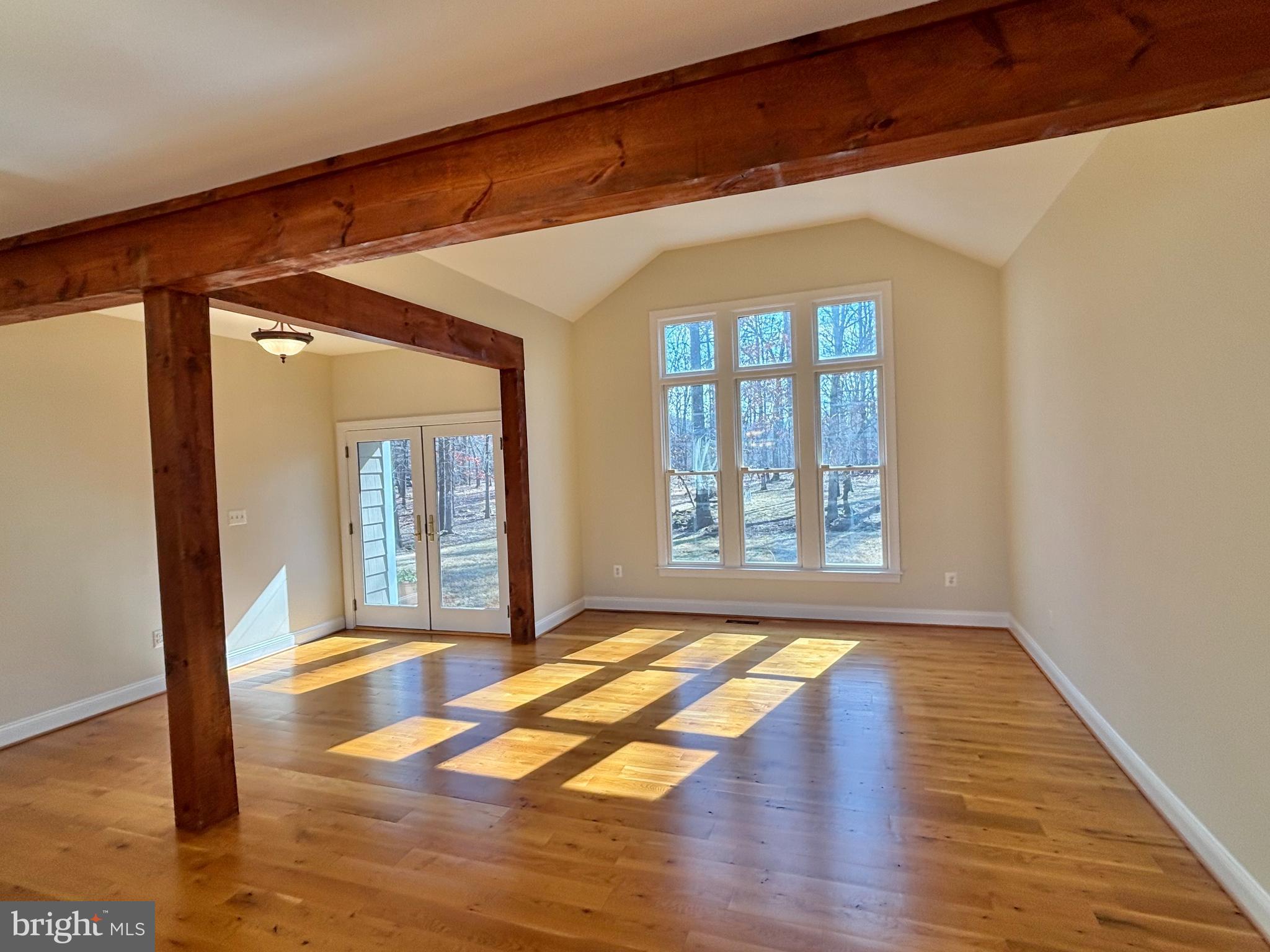 37218 Bolyn Road Purcellville, VA 20132 - Photo 19 of 62 a view of an empty room with wooden floor and a window