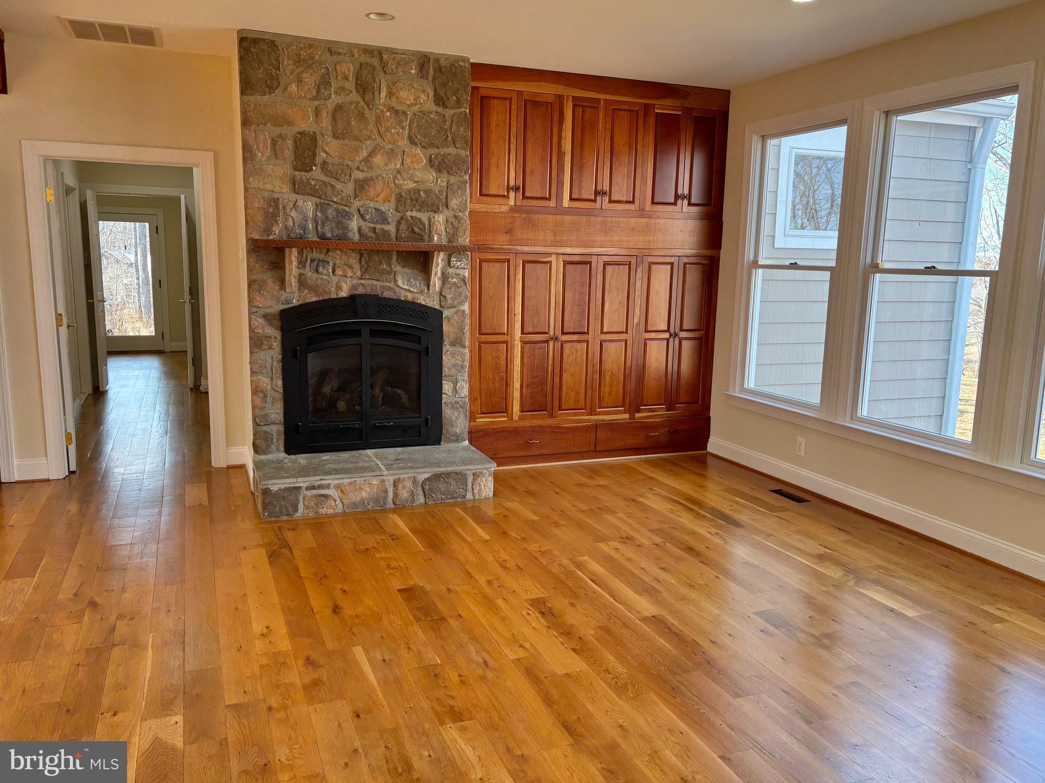 37218 Bolyn Road Purcellville, VA 20132 - Photo 20 of 62 a view of empty room with wooden floor and fireplace