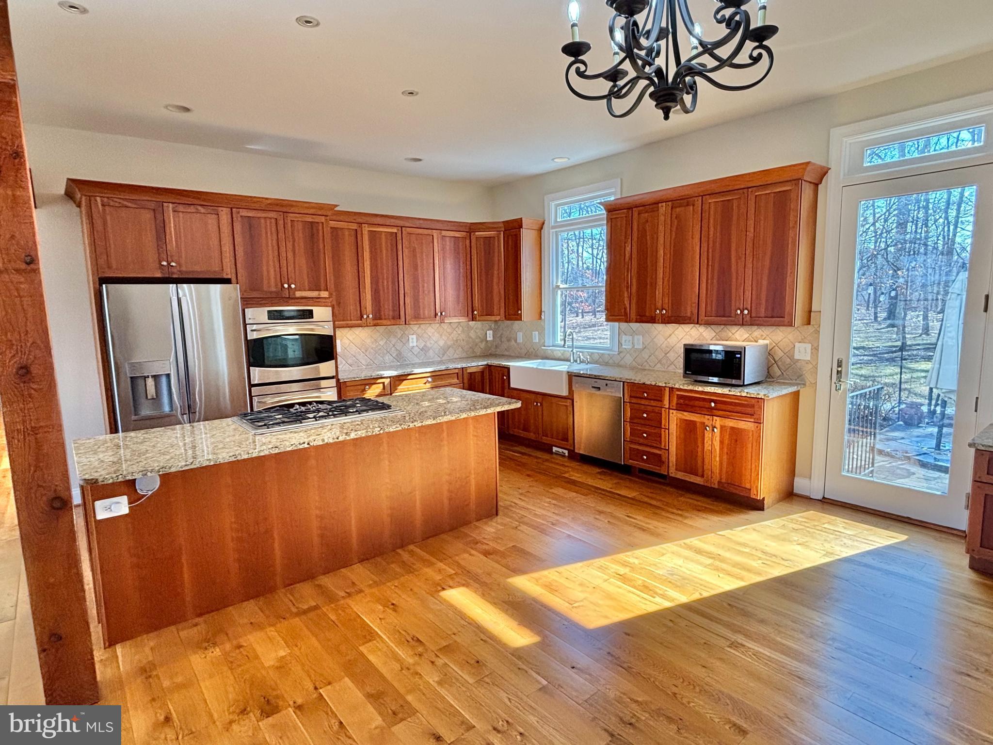 37218 Bolyn Road Purcellville, VA 20132 - Photo 22 of 62 a kitchen with stainless steel appliances a stove a sink a microwave a refrigerator cabinets and a window