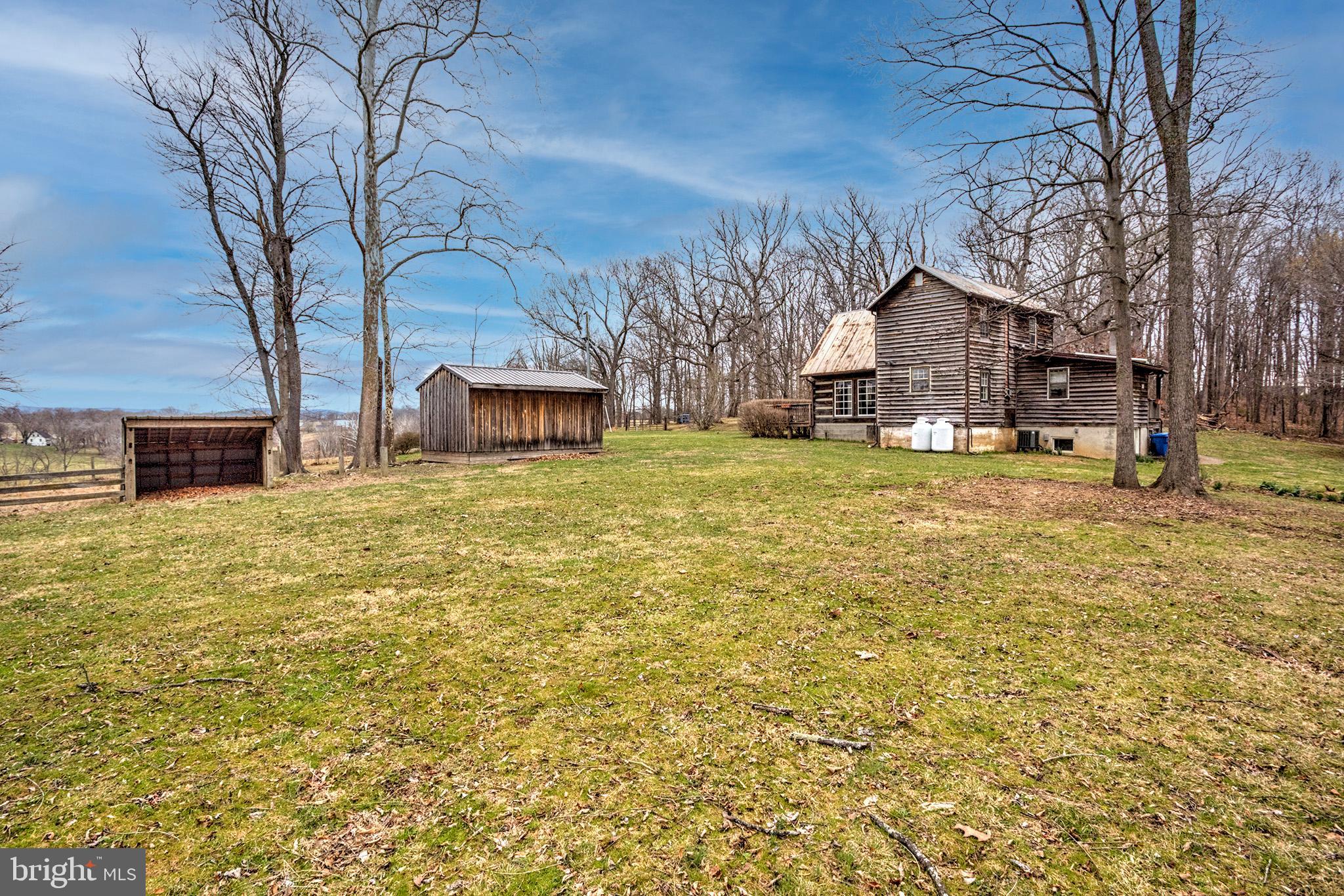 37218 Bolyn Road Purcellville, VA 20132 - Photo 53 of 62 a view of a house with a yard covered with trees