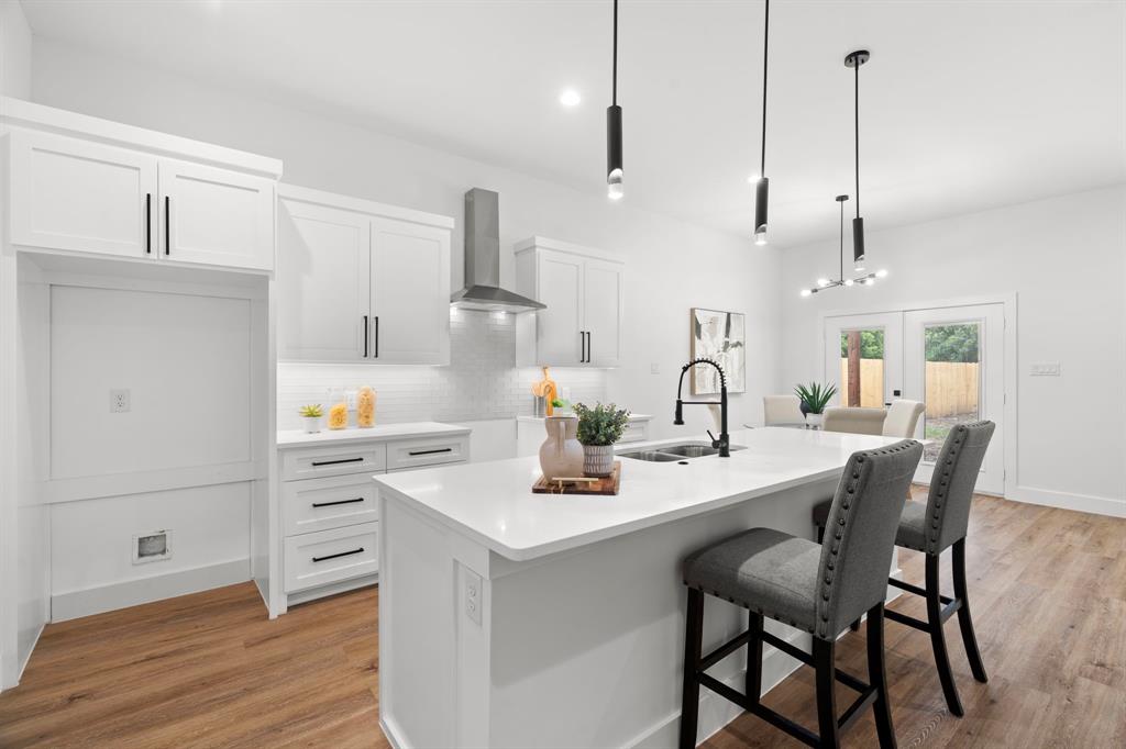 2227 Fordham Road Dallas, TX 75216 - Photo 11 of 30 a kitchen with a dining table chairs and cabinets