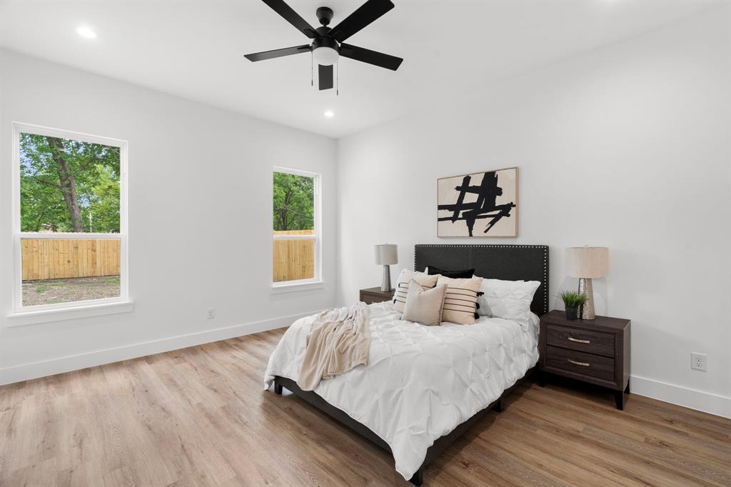 2227 Fordham Road Dallas, TX 75216 - Photo 12 of 30 a bedroom with a bed and wooden floor
