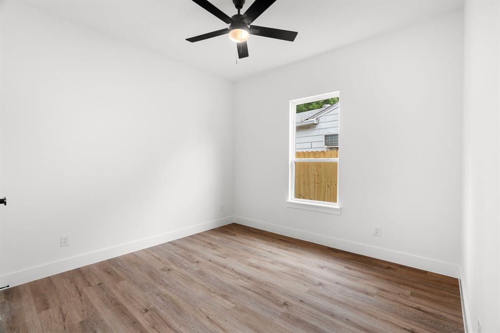 2227 Fordham Road Dallas, TX 75216 - Photo 22 of 30 a view of an empty room with wooden floor and a window