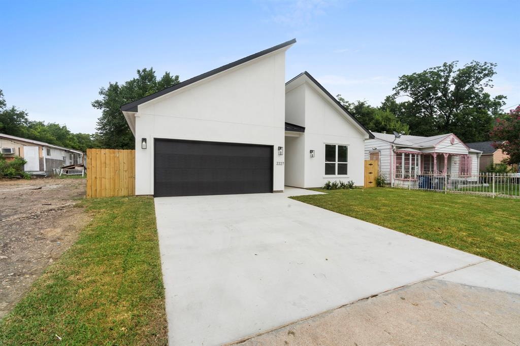 2227 Fordham Road Dallas, TX 75216 - Photo 24 of 30 a front view of house with yard and garage
