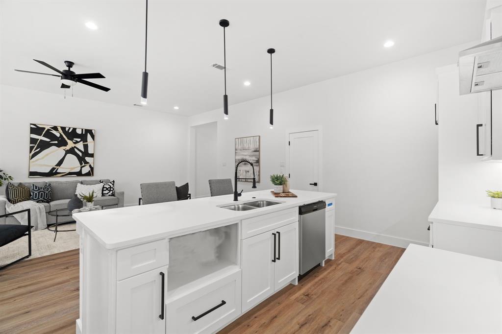 2227 Fordham Road Dallas, TX 75216 - Photo 29 of 30 a kitchen with a sink a stove and a wooden floor