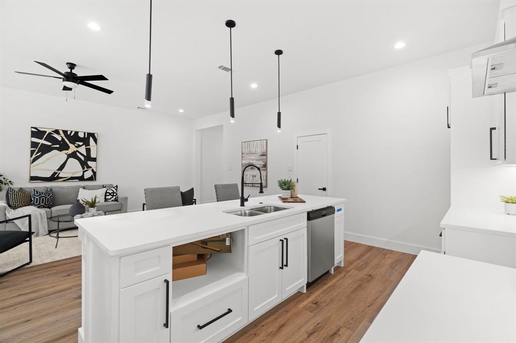 2227 Fordham Road Dallas, TX 75216 - Photo 5 of 30 a kitchen with a sink a stove and a wooden floor