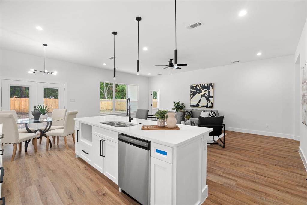 2227 Fordham Road Dallas, TX 75216 - Photo 7 of 30 a view of a kitchen with kitchen island a stove a wooden floor