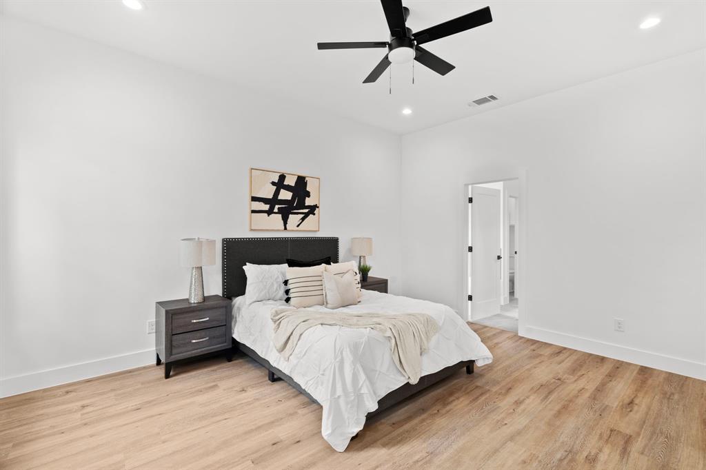 2227 Fordham Road Dallas, TX 75216 - Photo 9 of 30 a bedroom with a bed and wooden floor