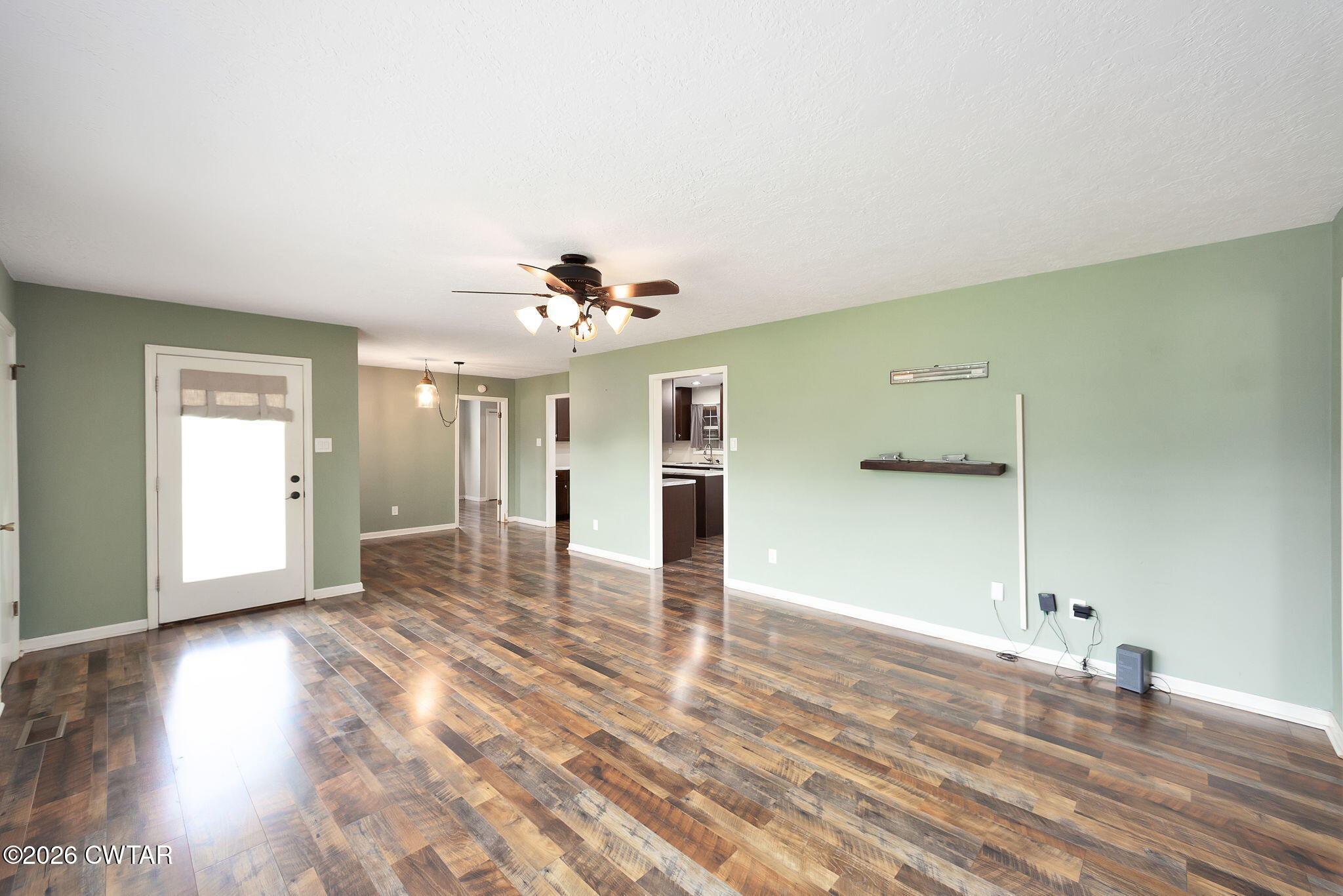 306 Jim Jackson Road Humboldt, TN 38343 - Photo 8 of 29 a view of an empty room and window and wooden floor