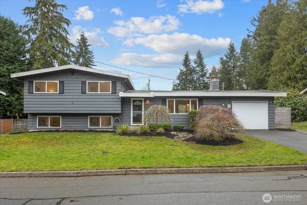 a front view of a house with a yard and garage