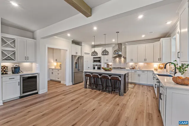 a view of a kitchen with wooden floor and electronic appliances
