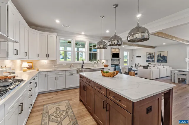 a kitchen with granite countertop white cabinets and white appliances