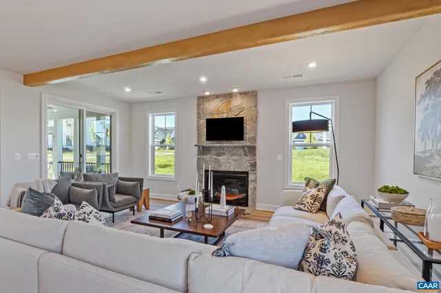 a living room with furniture fireplace and a flat screen tv
