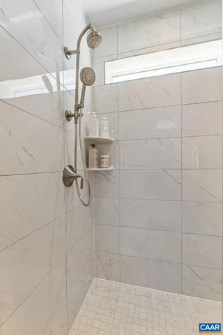 a spacious bathroom with double sink and a mirror