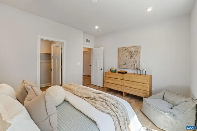 a front view of a house with glass windows and plants