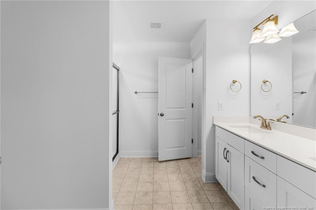 176 Josey Williams Road Erwin, NC 28339 - Photo 27 of 40 a spacious bathroom with a double vanity sink a mirror and a shower