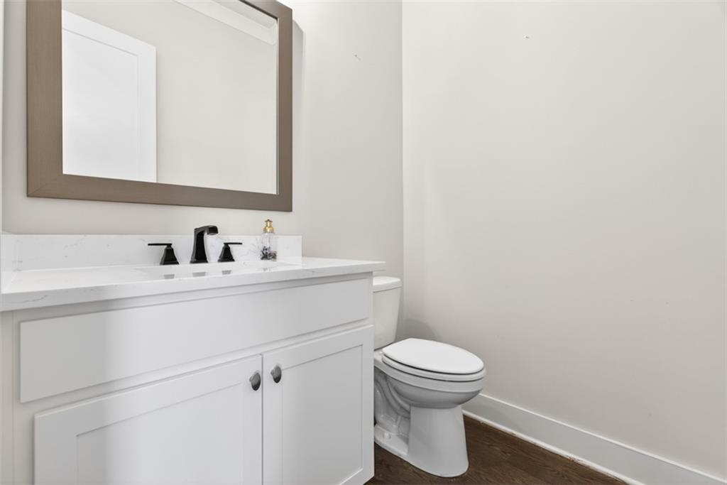 3528 North Bogan Road Buford, GA 30519 - Photo 21 of 79 a bathroom with a toilet sink and mirror