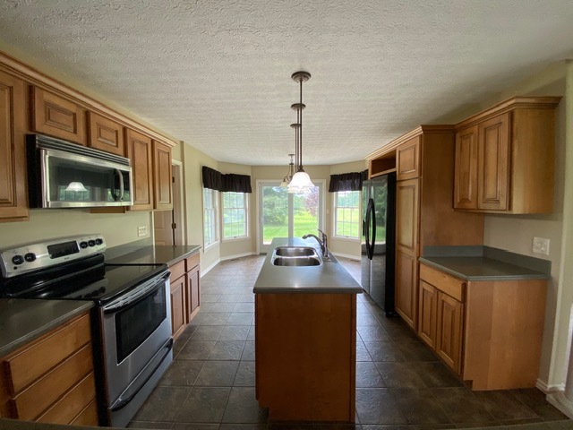 11426 East Radisson Road Mount Vernon, IL 62864 - Photo 4 of 56 a kitchen with stainless steel appliances granite countertop a stove a sink and a refrigerator