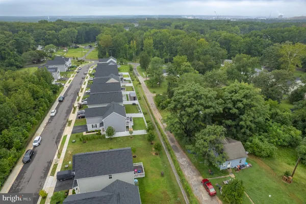 an aerial view of residential houses with outdoor space and street view