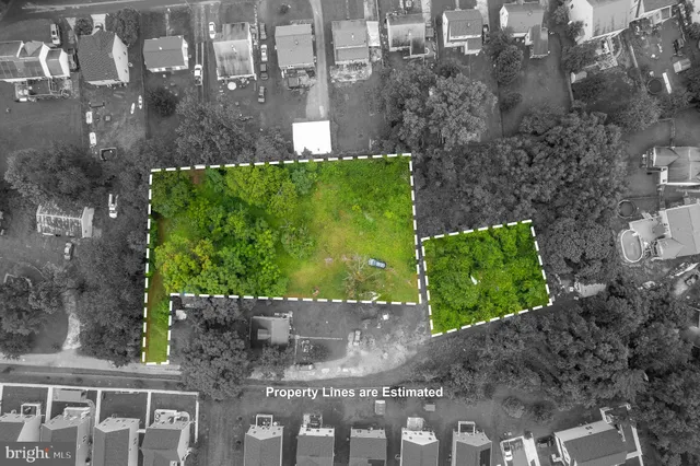 an aerial view of residential house with outdoor space and trees all around