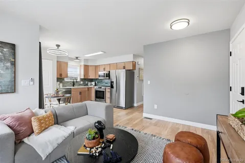 a living room with furniture and a potted plant
