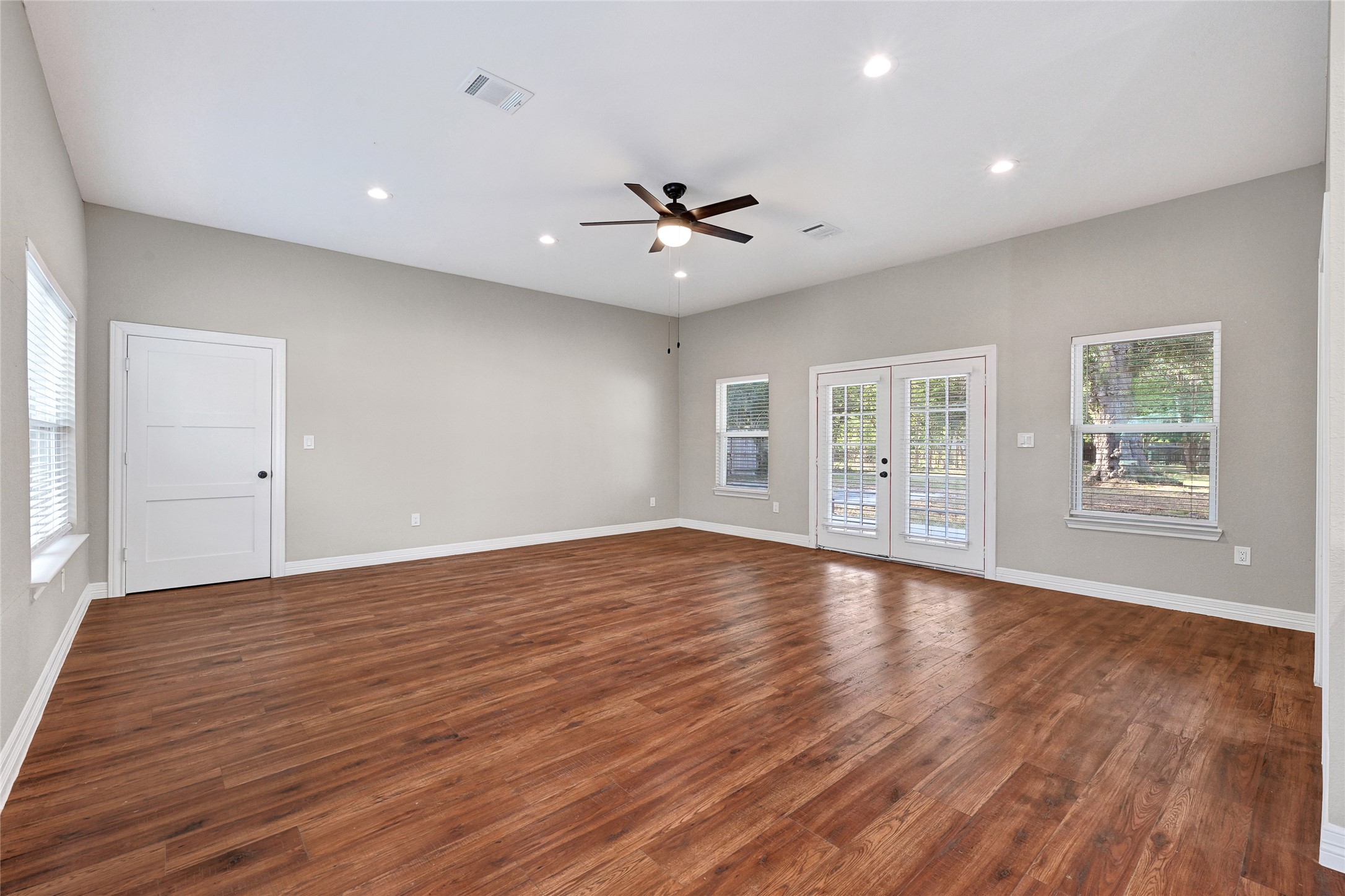 7045 Cayton Street Houston, TX 77061 - Photo 13 of 37 a view of an empty room with wooden floor and a window