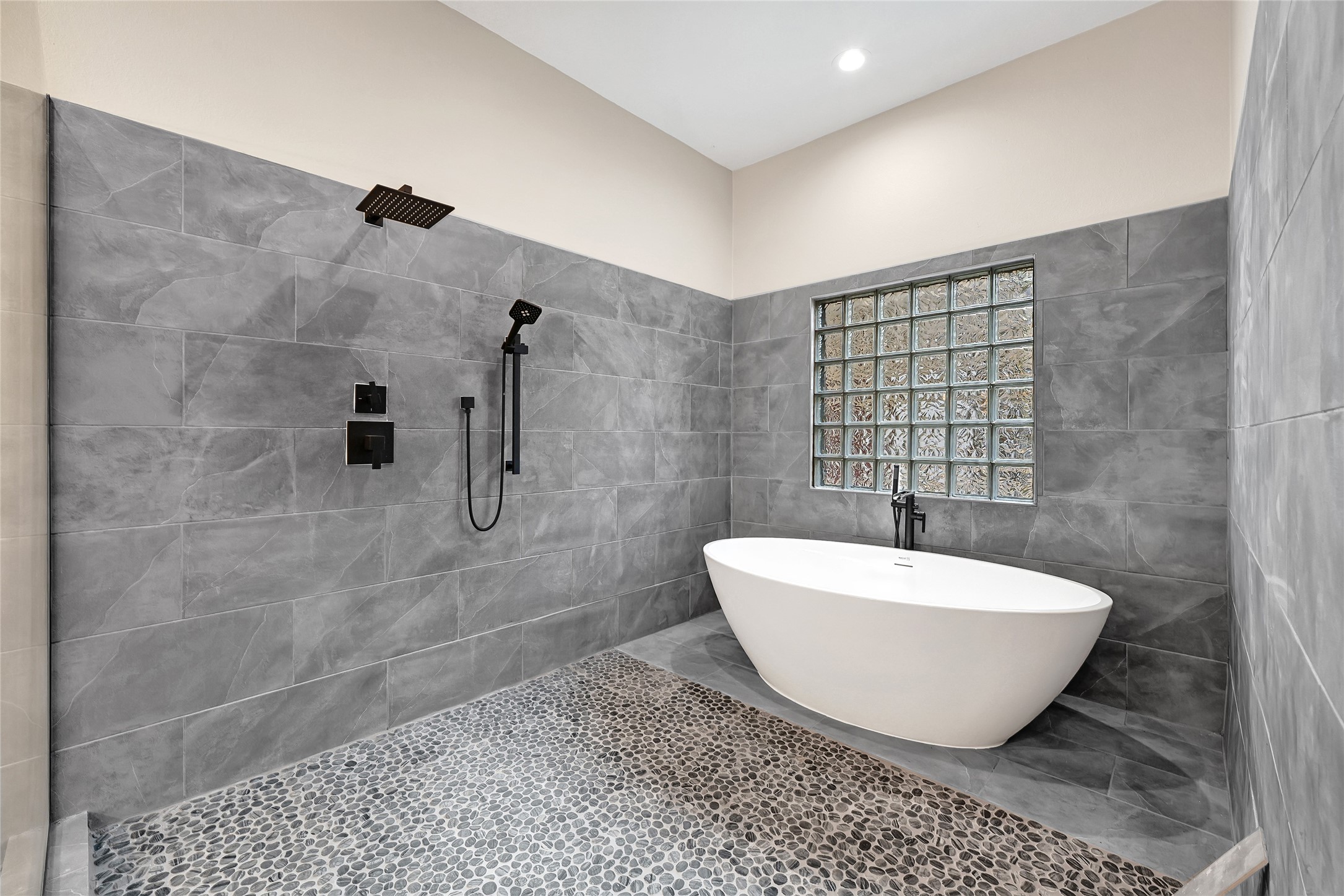 7045 Cayton Street Houston, TX 77061 - Photo 21 of 37 a bathroom with a bathtub and shower