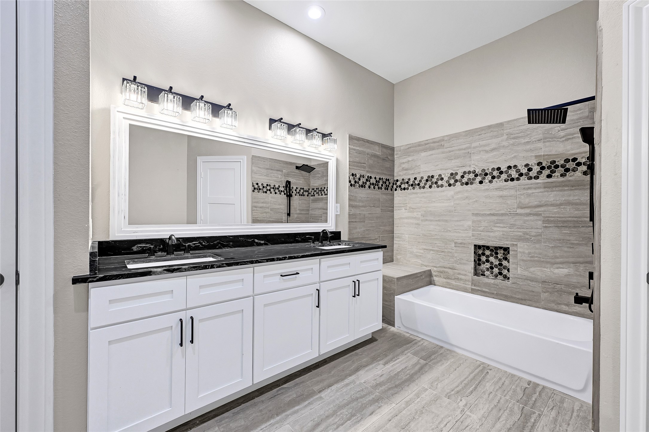 7045 Cayton Street Houston, TX 77061 - Photo 28 of 37 a bathroom with a tub sink and mirror