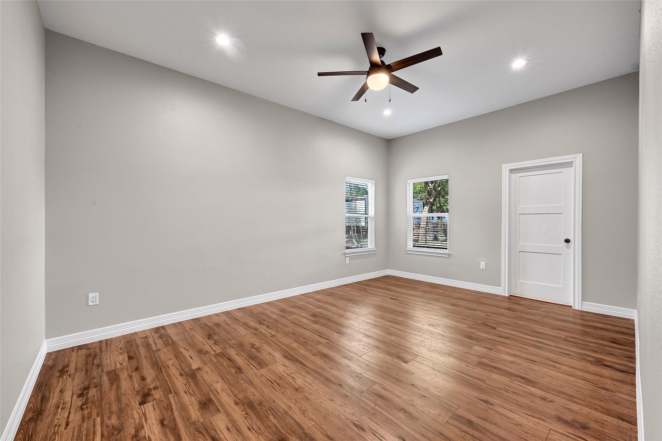 7045 Cayton Street Houston, TX 77061 - Photo 30 of 37 an empty room with wooden floor and windows