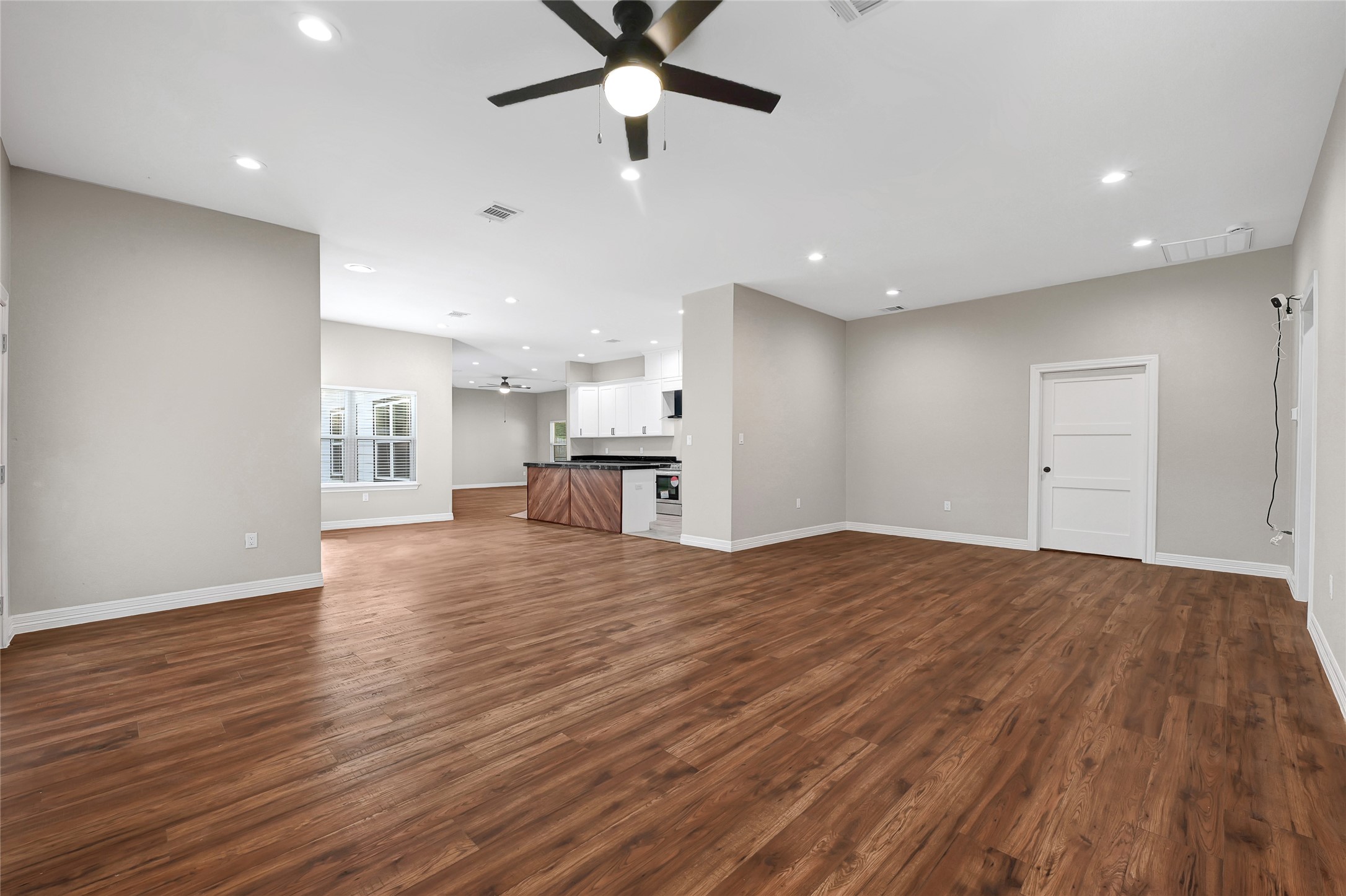 7045 Cayton Street Houston, TX 77061 - Photo 6 of 37 a view of empty room with wooden floor and a ceiling fan