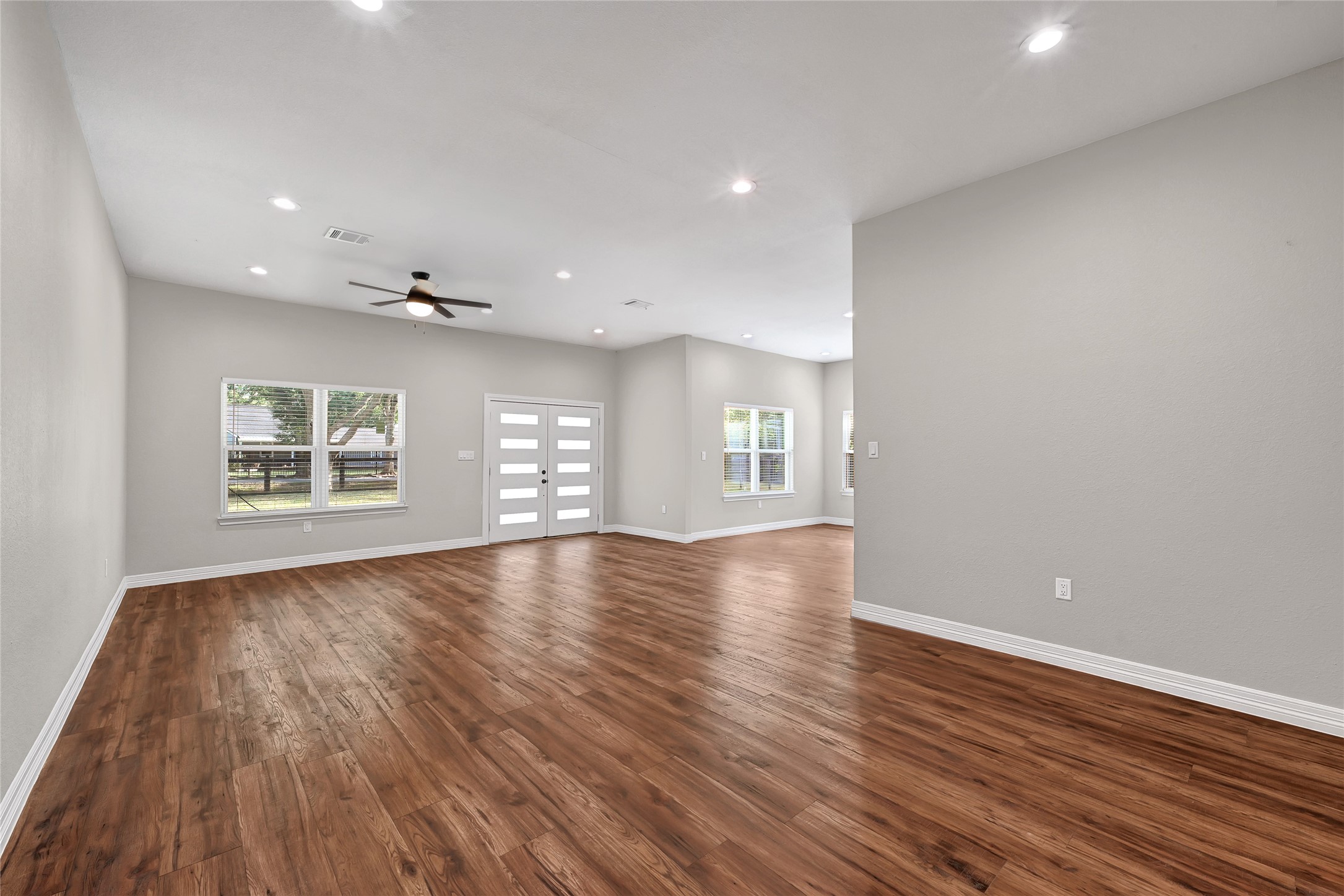 7045 Cayton Street Houston, TX 77061 - Photo 7 of 37 wooden floor in an empty room with a window