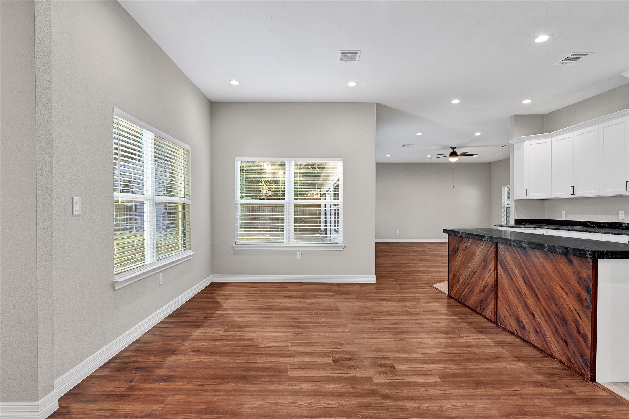 7045 Cayton Street Houston, TX 77061 - Photo 9 of 37 a view of empty room with wooden floor and kitchen