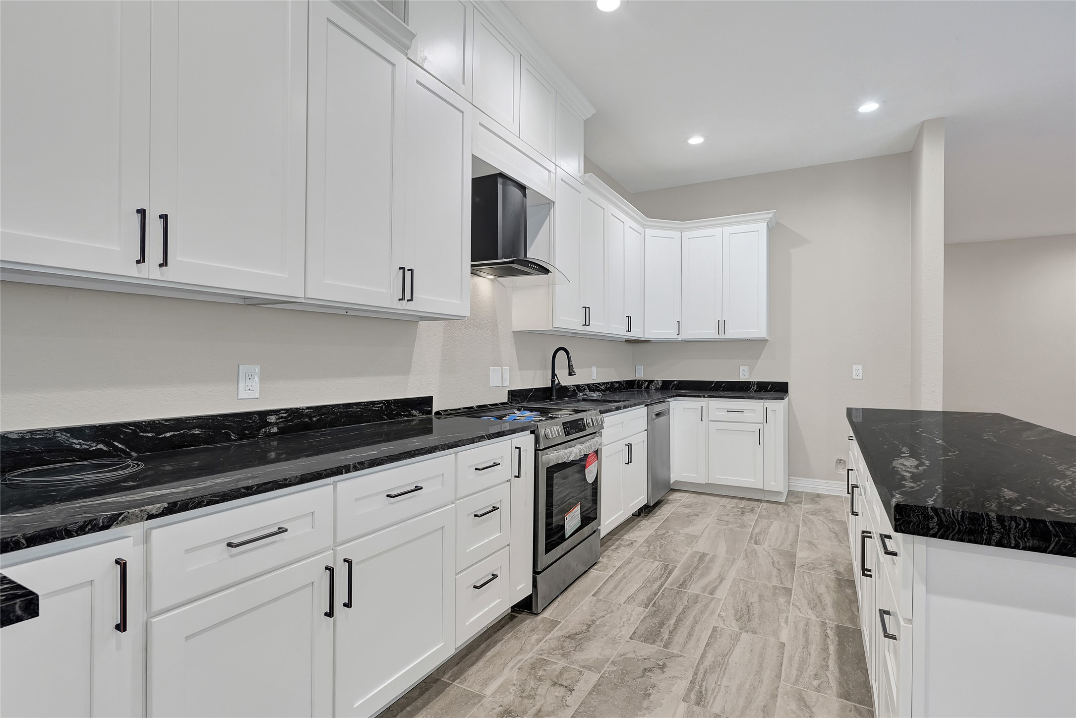 7045 Cayton Street Houston, TX 77061 - Photo 10 of 37 a kitchen with granite countertop white cabinets and white appliances